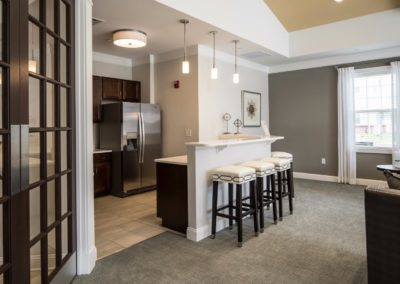 coffee station and kitchen in the resident lounge at Jacksonville Station’s Warminster apartments