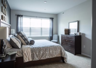 bedroom with large windows in a Warminster apartment at Jacksonville Station